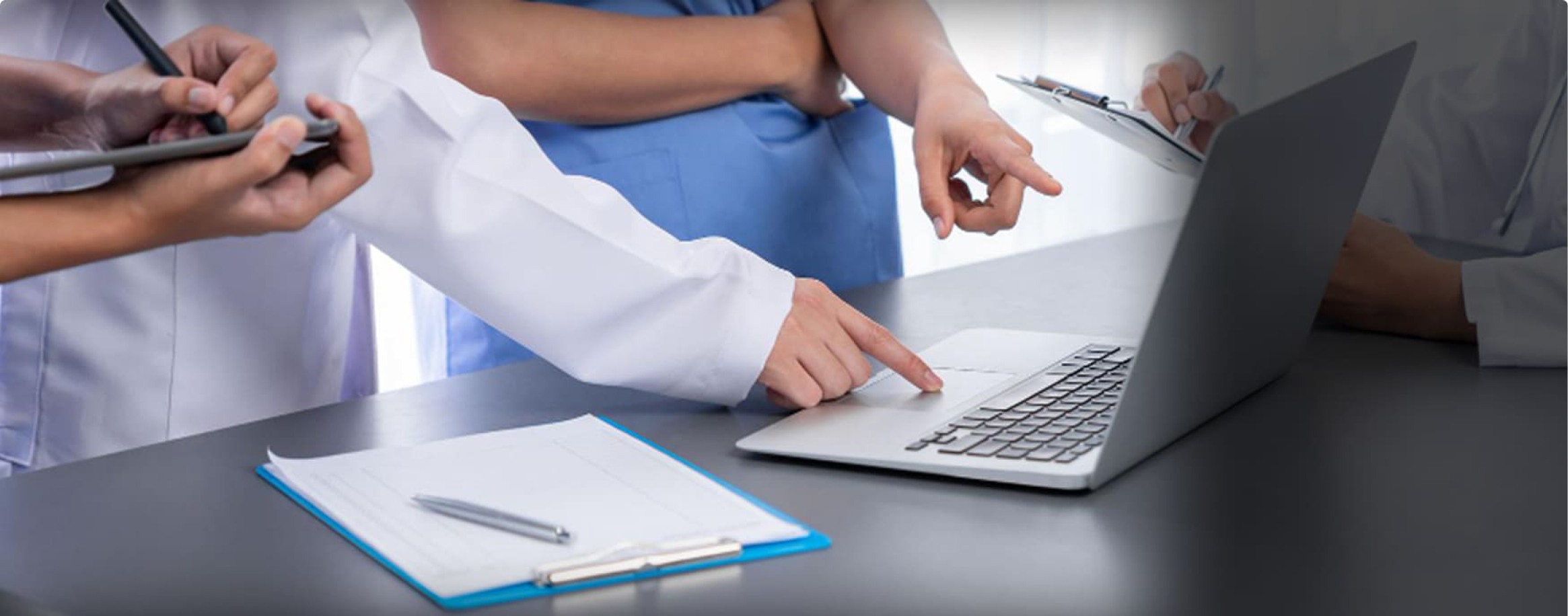 Healthcare professionals reviewing connected partner systems on a laptop and tablet