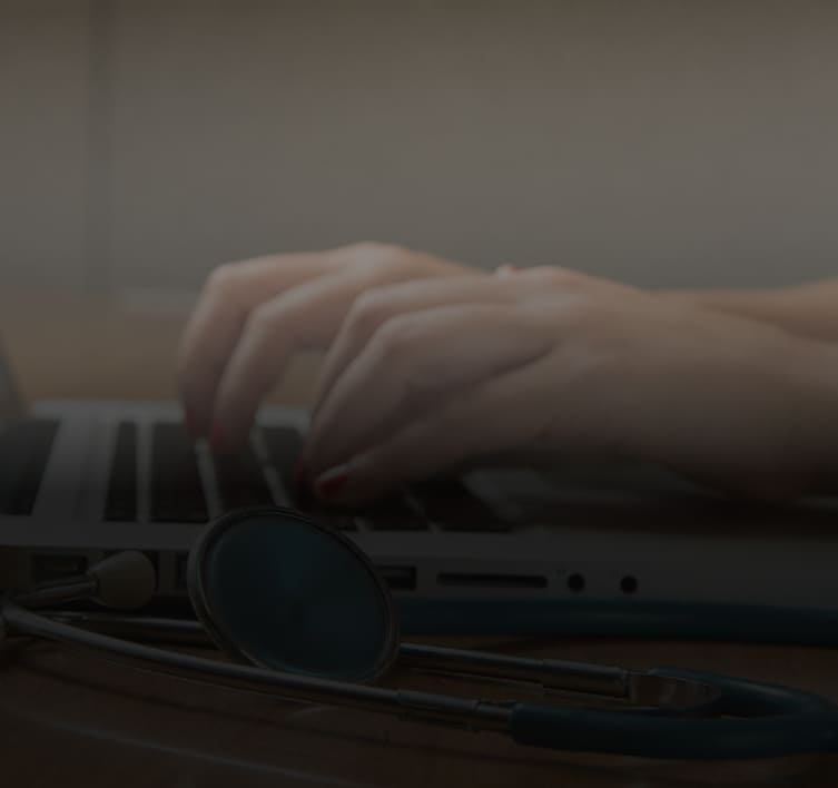 Clinician typing at a workstation